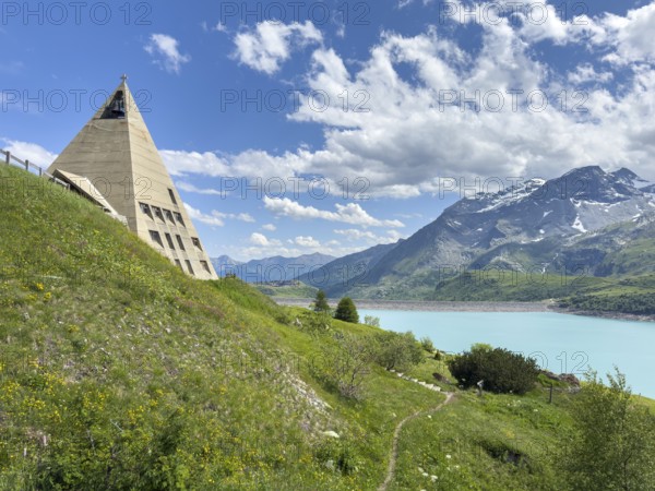 View of left Museum Musée du Mont Cenis on pass road to pass Alpine pass mountain pass Col du Mont Cenis Colle del Moncenisio, right reservoir Lac du Mont Cenis with Barrage dam wall in the background, Mont Cenis massif, Massif du Mont-Cenis, Graian Alps, Lanslebourg, Rhone-Alpes, France