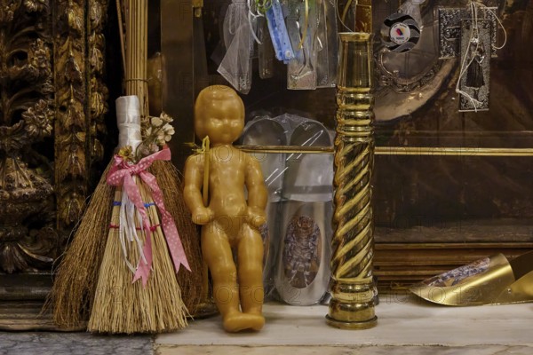 Symbolic objects in a religious context, including doll and broom, framed by gilded decorations, Holy Week, Bay of Panormitis, Panormitis Monastery, Symi, Dodecanese, Greek Islands, Greece
