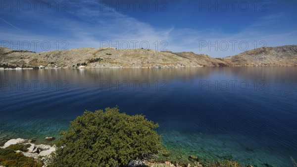 Clear bay surrounded by rocky hills under a blue sky, Bay of Emporio, Emporio, Symi, Dodecanese, Greek Islands, Greece