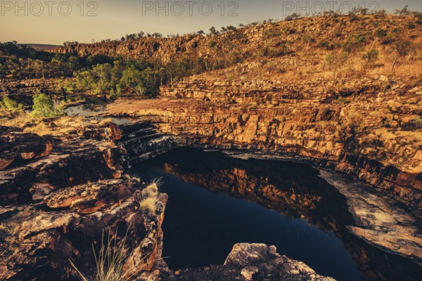 Bell Gorge waterfall, a body of water in north-west Australia in the Kimberley. Sunrise in the outback, Australia