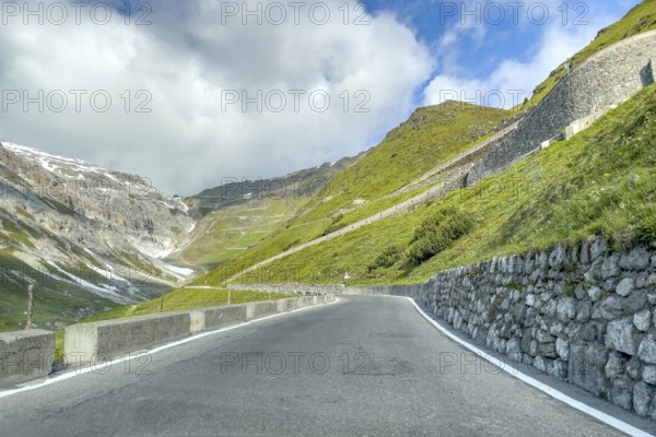 View of east ramp ascent to descent from Alpine pass Stelvio Stilfserjoch mountain road above tree line, top right masonry of serpentine built into the steep slope, centre in the background many serpentines hairpin bends lead to pass summit of 2757 2758 metres high pass road mountain pass with tight bends hairpin bends Stelvio Stelvio, Stilfs, South Tyrol, Alto Adige, Italy