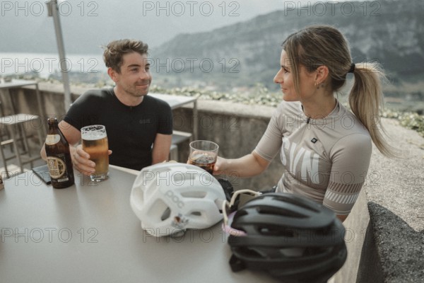 Woman and man cycling on Lake Garda in Italy. Sunny weather and dolce vita