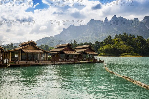 Floating houses on lake with jungle and rainforest and steep mountains, Cheow Lan Lake, Khao Sok National Park, Phang Nga, Surat Thani, Thailand