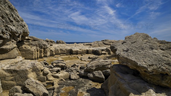 Expansive rocky landscape under a blue sky, Oasis Beach, east coast of Rhodes, Rhodes, Dodecanese, Greek islands, Greece