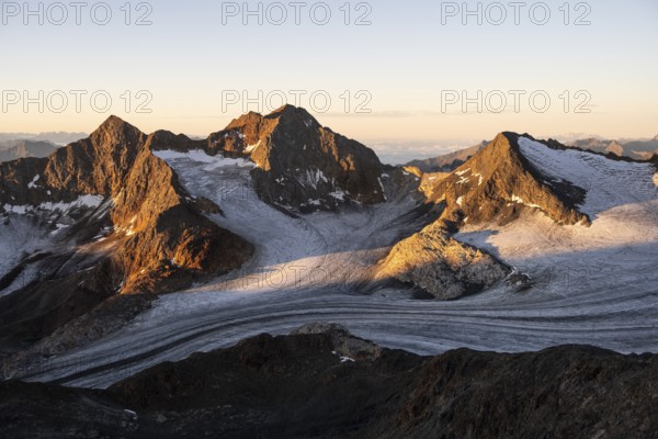 Picturesque high mountain landscape at sunrise with alpenglow, glacier and rocky mountain peaks in the morning light, view of the Königshofspitz mountain peak and Übeltalferner glacier, Stubai Alps, South Tyrol, Italy