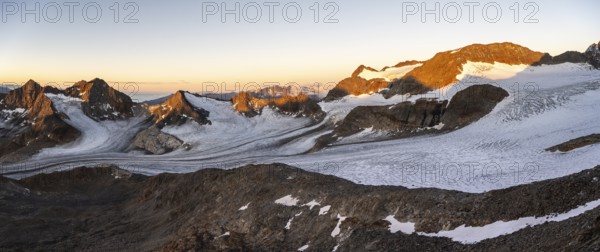 Picturesque high mountain landscape at sunrise with alpenglow, glacier and rocky mountain peaks in the morning light, view at Becher of mountain peaks Königshofspitz and Sonklarspitze and Schwarzwandspitz with glacier Übeltalferner, Stubai Alps, South Tyrol, Italy