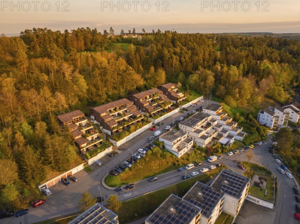 Overview of housing estate on a hill, surrounded by trees, warm sunlight, Nagold, Black Forest, Germany