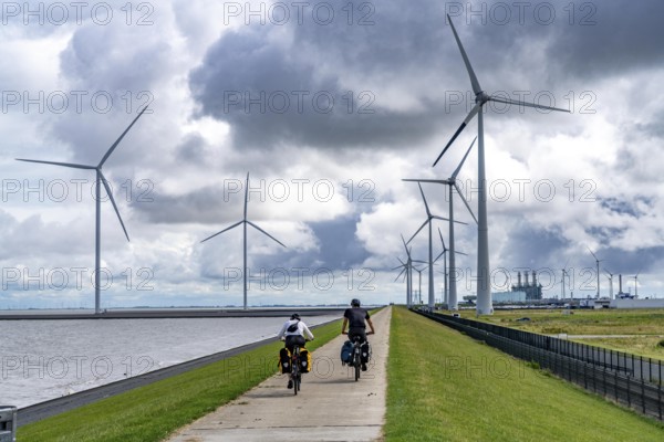 Strekdammen Wind Farm, wind farm at the seaport of Eemshaven in the Netherlands, left, built on offshore breakwaters, 2 GE Cypress 5, 5 MW turbines, with 158 metre blade diameter, together produce 11 MW of power, can supply 15, 500 households with electricity from wind, cumulus cloud over the North Sea, Netherlands