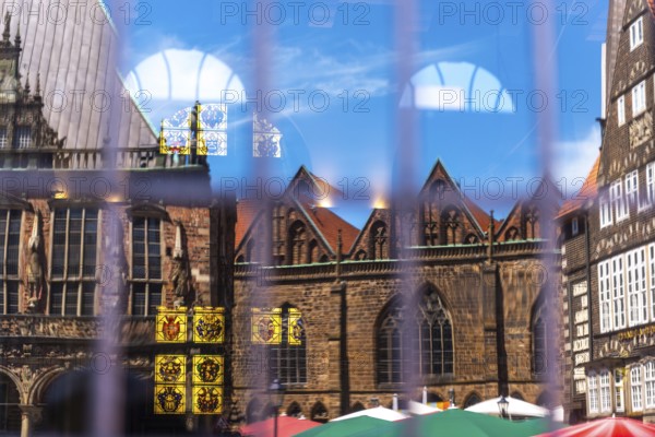 Cherry nave of the Church of Our Lady, Town Hall and German House Market (right) reflected in the window of the Schütting, the building of the Bremen merchants, Chamber of Industry and Commerce, stained glass window in the Chamber of Industry and Commerce, listed building, Old Town, Hanseatic City of Bremen, Germany