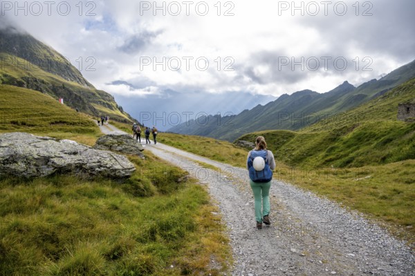 Hiker on a forest path near the Martalm, Lazzacher Tal, Seven Lakes Hike, Stubai Alps, near Ridnaun, South Tyrol, Italy