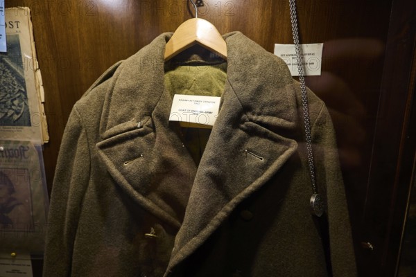 Old British military coat on a hanger in an illuminated wooden display case, War Museum, Military Museum, Tunnel Museum, Lakki, Leros, WW2, Dodecanese, Greek Islands, Greece