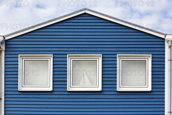 Blue lobster shack, wooden façade with three windows, façade detail in the harbour, Heligoland, Schleswig-Holstein, Germany