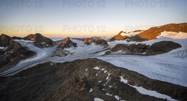 Picturesque high mountain landscape at sunrise with alpenglow, glacier and rocky mountain peaks in the morning light, mountain peaks Königshofspitz and Hofmannspitze with glacier of the Übeltalferner, Stubai Alps, South Tyrol, Italy