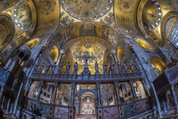 Wide angle view of the richly decorated interior of saint mark's basilica, highlighting the intricate frescoes, golden mosaics, and religious sculptures