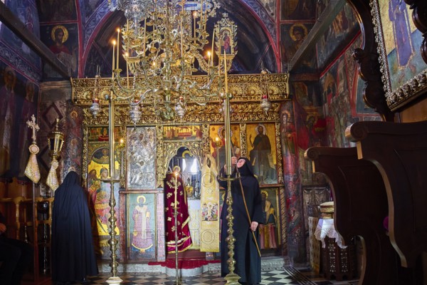 Zoodochou Pigis Monastery, Nunnery, Iconostasis, Richly decorated church interior with icons and priest in festive robes, Church, Chora, World Heritage Site 1999, Patmos, Dodecanese, Greek Islands, Greece
