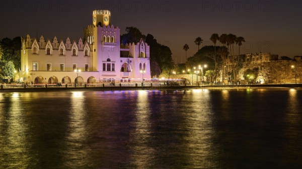 Palace of Justice, colonial building, night shot of a historic building with lights, palm trees and water, reflecting a warm romantic atmosphere, Kos Town, Kos, Dodecanese, Greek Islands, Greece