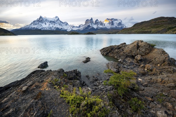 Cuernos del Paine mountain range at sunset, shore of the blue lake Lago Pehoe, Torres del Paine National Park, Chile