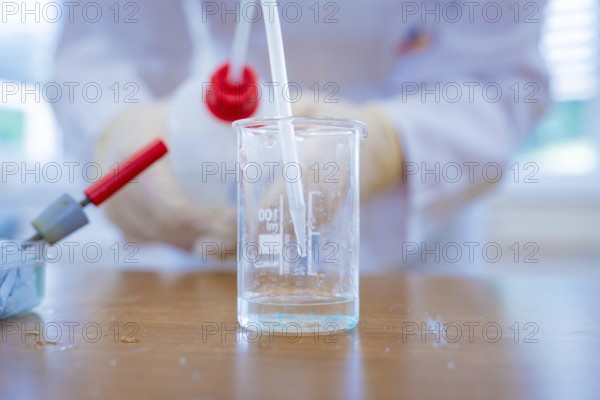 Close-up of a beaker with liquid and pipette in the laboratory, Battery Research, Nagold, Germany