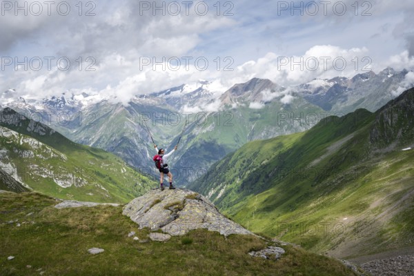 Mountaineer on a rock at the Mittagskögele, view of mountain peaks of the Venediger group and the Lasnitzental valley, Lasörling Höhenweg, Lasörling group, Hohe Tauern National Park, East Tyrol, Tyrol, Austria
