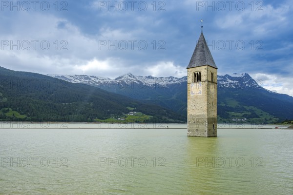Bell tower of the former parish church of St Catherine in the sunken village of Alt-Graun in Lake Reschen in Vinschgau, South Tyrol, Italy