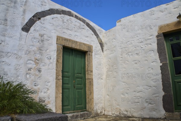 Green wooden door in a thick, whitewashed wall under a blue sky, Monastery of the Revelation, Moni tis Apokalipsis, World Heritage Site 1999, Patmos, Dodecanese, Greek Islands, Greece
