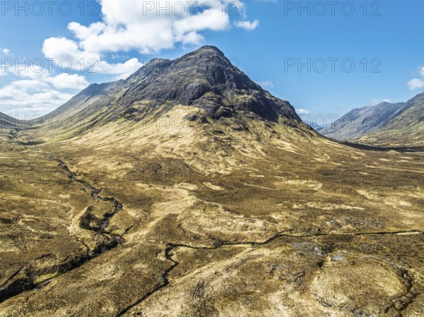Buachaille Etive Beag and Three Sisters in Glencoe over Moors and Road A82 from a drone, Highlands, Scotland, United Kingdom