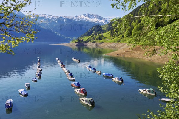 Motorboats moored at the reservoir, snow-covered Alps in the background, Lake Wägital, Canton Schwyz, Switzerland