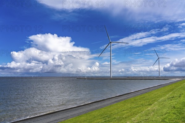 Strekdammen Wind Farm, wind farm at the seaport of Eemshaven in the Netherlands, built on offshore breakwaters, 2 GE Cypress 5, 5 MW turbines, with 158 metre blade diameter, together produce 11 MW of power, can supply 15, 500 households with electricity from wind, cumulus cloud over the North Sea, Netherlands