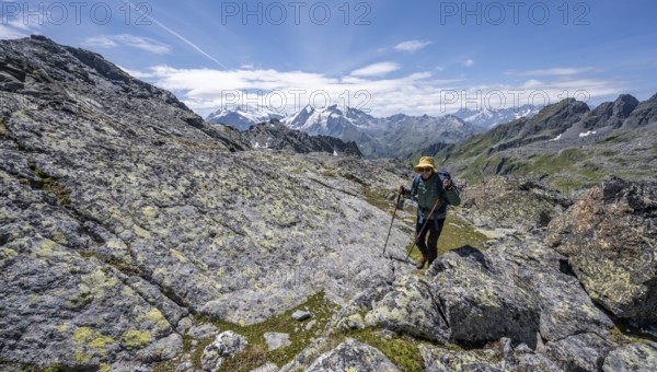 Mountaineer in rocky mountain landscape at the Col du Louvie, view of the summit of the Grand Combine, Valais Alps, Val de Bagnes, Valais, Switzerland