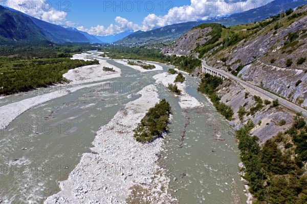 Unregulated river course in a natural riverbed, the Rhone, also known as the Rotten, flows through the Rottensand alluvial plain near Varen, Leuk, Valais, Switzerland