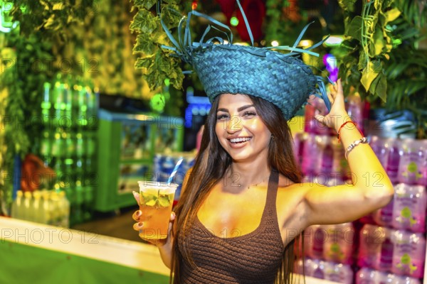 Beautiful young woman enjoying a refreshing cocktail at a vibrant brazilian carnival celebration, surrounded by festive decorations