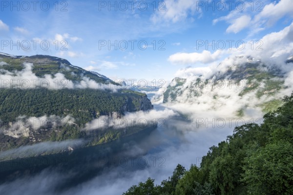 View over the Geirangerfjord, atmospheric clouds over the fjord in the morning light, Ørnesvingen viewpoint, near Geiranger, Møre og Romsdal, Norway