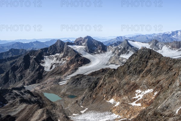 View of mountain basin with blue glacier lakes, behind summit Becher with Becherhaus, glacier Übeltalferner and summit Königshofspitz, descent from summit Wilder Freiger to Roter Grat, Stubai Alps, South Tyrol, Italy