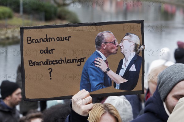 Friedrich Merz kisses Alice Weidel, banner on the topic of the firewall, demonstration against right-wing extremism on 25 February 2025, Düsseldorf, North Rhine-Westphalia, Germany