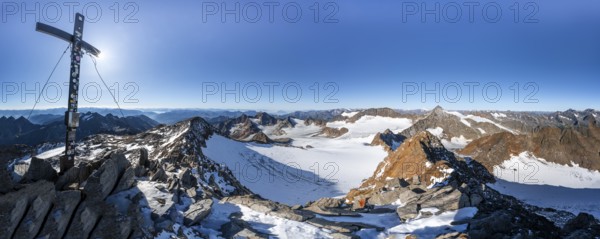 Mountain panorama at the Wilder Freiger summit with summit cross, picturesque high mountain landscape with snow, view of the Übeltalferner glacier and rocky mountain peaks Königshofspitz and Sonklarspitze, Wilder Pfaff, Stubai Alps, South Tyrol, Italy