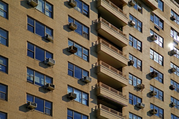 Brick façade of a high-rise building with air conditioning for the flats, New York City, USA
