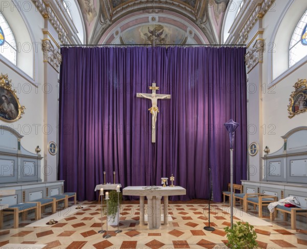 Large purple Lenten cloth in front of the high altar in the baroque parish church of St Nicholas, built between 1722 and 1724, Kirchacker 20, Tannheim, Austria