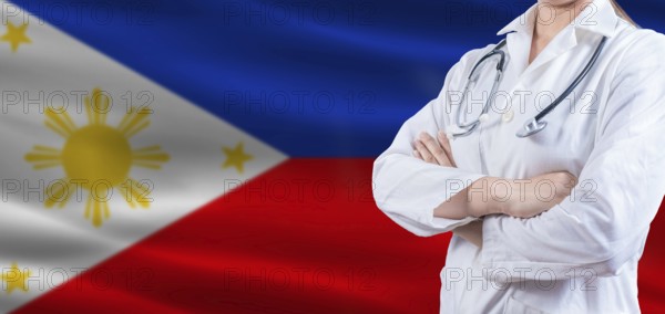 Doctor with crossed arms on Philippines flag. Philippines health and care concept. Female doctor on Philippines flag