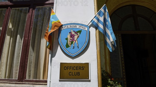 Building with sign of the officers' club, Greek flag and coat of arms, harbour area, Rhodes Town, Rhodes, Dodecanese, Greek Islands, Greece