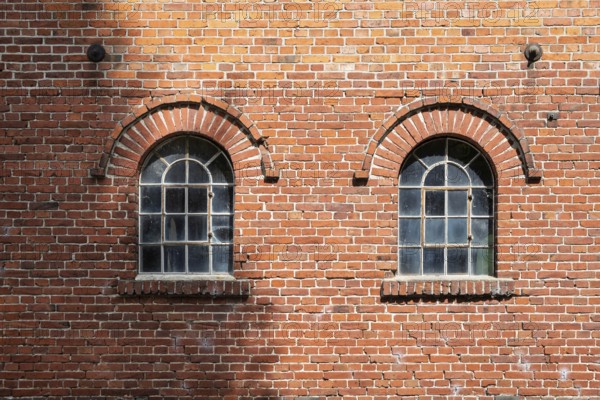 Old windows in a traditional brick wall with rustic charm and visible reflections, Stiftsmühle, Ochtrup-Langenhorst, Münsterland, North Rhine-Westphalia, Germany