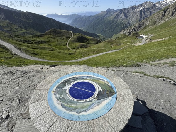 In front orientation board at viewpoint on third highest asphalted pass in the Alps highest border pass in the High Alps Alpine pass above tree line behind view of southern ramp southern ascent mountain road Alpine road to 2744 metre high Col d'Agnel, Colle dell'Agnello, Pontechianale, Italy