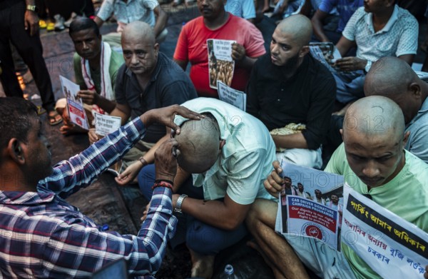 Drivers affiliated with Ola, Uber, and Rapido, under the banner of the Assam State Drivers' Union and the All Assam Cab Welfare Federation, shaved their heads in protest in Guwahati, India, on July 22, 2025. The demonstration held to highlight their demands for fair fare rates, regulation of aggregator commissions, and access to social security and welfare benefits