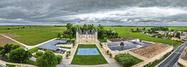 Panorama of Chateau Pichon Longueville Baron Vineyard and grape fields around Pauillac from a drone, Bordeaux, Gironde, Nouvelle-Aquitaine, France