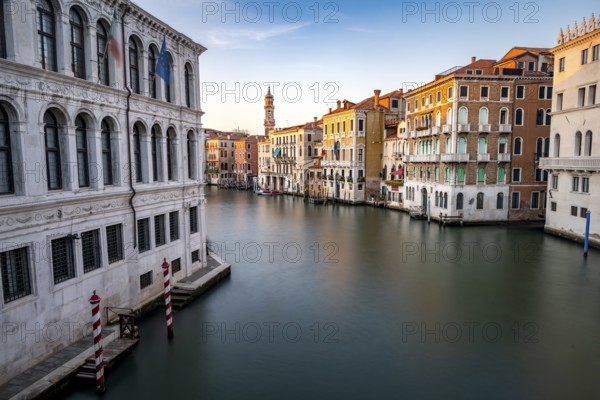 View of the Grand Canal at sunset, long exposure, picturesque evening mood with palazzos on the canal and church tower of the Chiesa Parrocchiale dei Santi Apostoli, view from the Rialto Bridge, Venice, Veneto, Italy