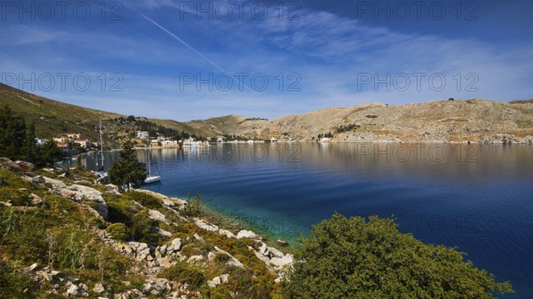 Coast with blue water and hilly landscape under a clear sky, Bay of Emporio, Emporio, Symi, Dodecanese, Greek Islands, Greece