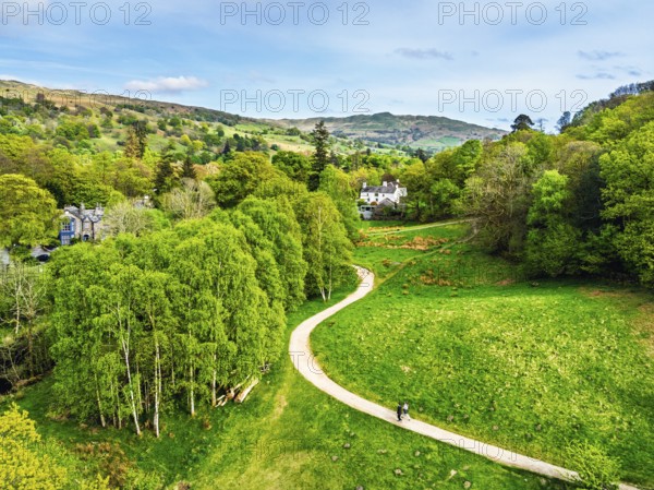 Farms and Mountains over road A591 from a drone, Grasmere Lake, Grasmere, Ambleside, Lake District, Westmorland, Cumbria, UK