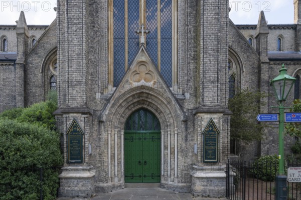 Neo-Gothic church entrance with green door, St James's Church, Norlands, architects Lewis Vulliamy, Robert Jewell Withers, Kensington, London, England, Great Britain