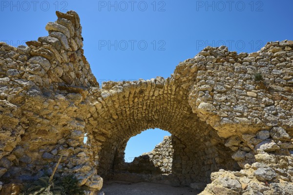 Ancient stone arch under a clear blue sky, Abandoned village, Lost place, Pyli, Paleo Pyli, Byzantine fortress, Kos, Dodecanese, Greek Islands, Greece