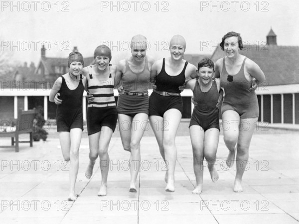 Group of woman in swimwear on a jetty, 1930s, woman in swimming costumes smiling and posing happily together, historical photo