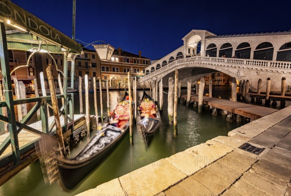 Rialto Bridge and gondolas on the Grand Canal, blue hour, long exposure, Venice, Veneto, Italy